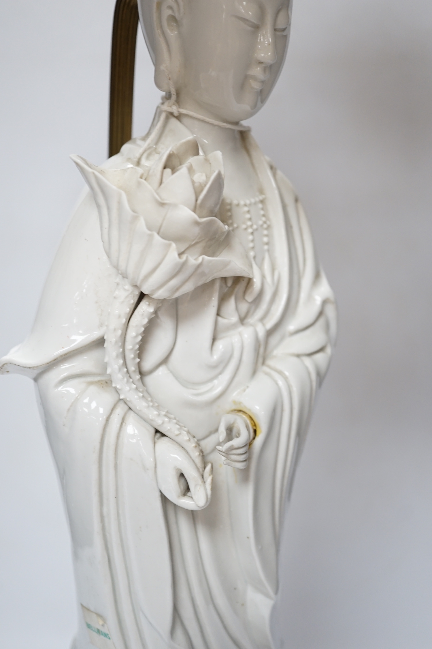 A Chinese blanc de chine figure of Guanyin, 71cm with shade